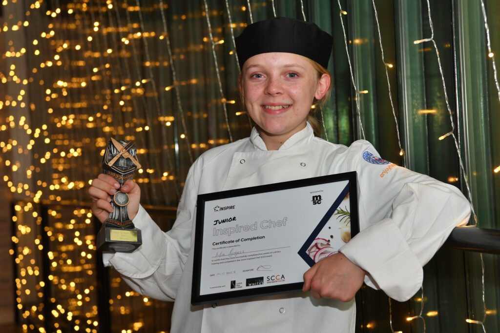 Junior Inspired chef competition winner Mia holding her trophy and certificate