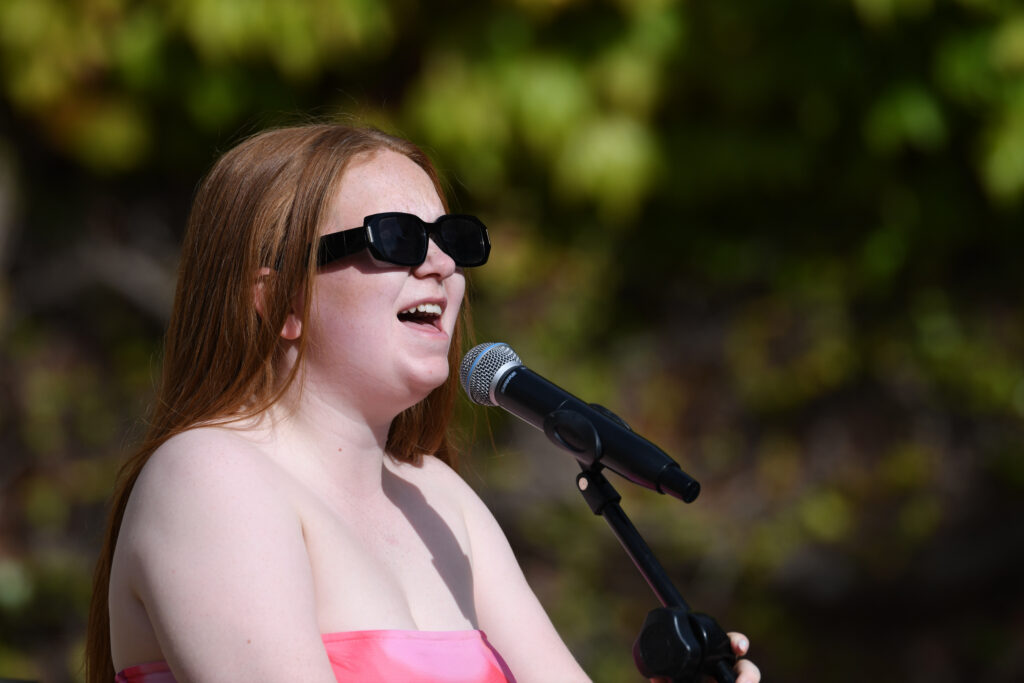 Holly singing at cricket and connections