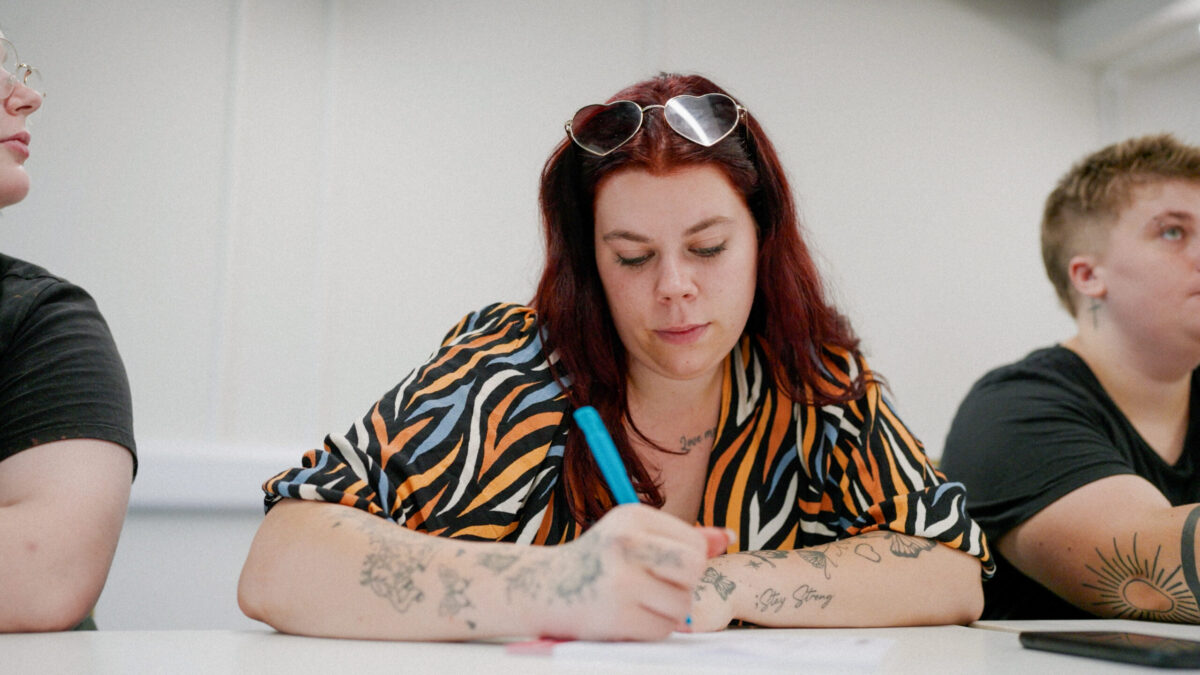 A young person from Inspire's YES service works on their CV in one of their classrooms.